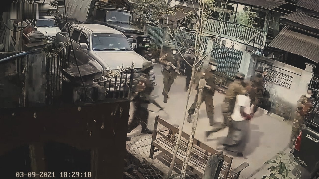 Image of Myanmar military patrolling streets photo taken from a window