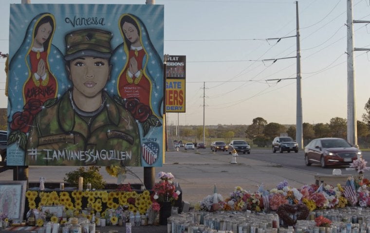 Photo of a memorial to soldier Vanessa Guillen. A painted portrait features her and two angels.