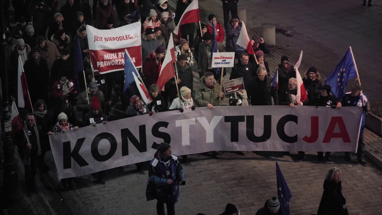 Image of protesters holding up signs