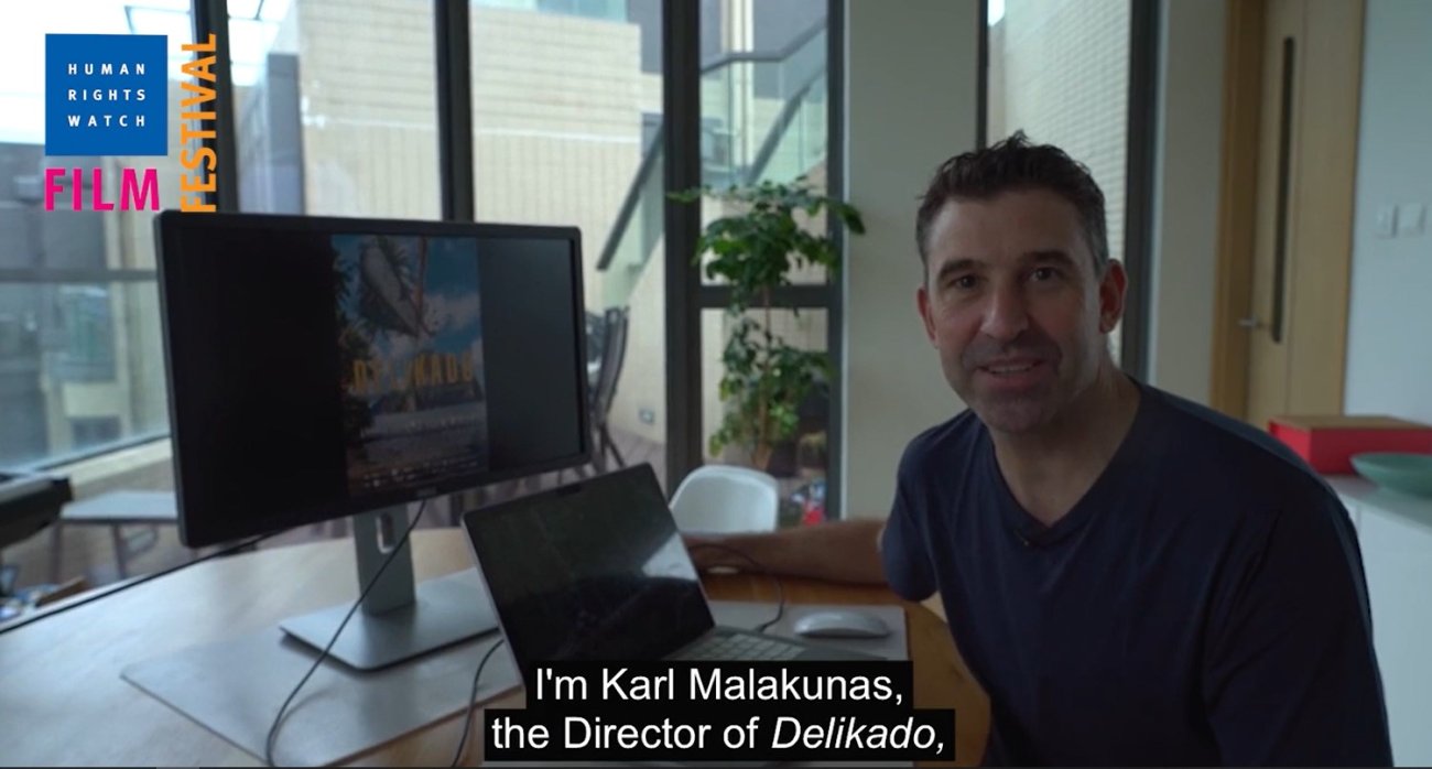 Filmmaker Karl Malakunas sits at his desk editing the film